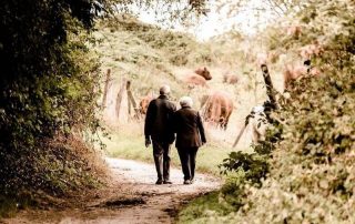 senior couple walking on a trail