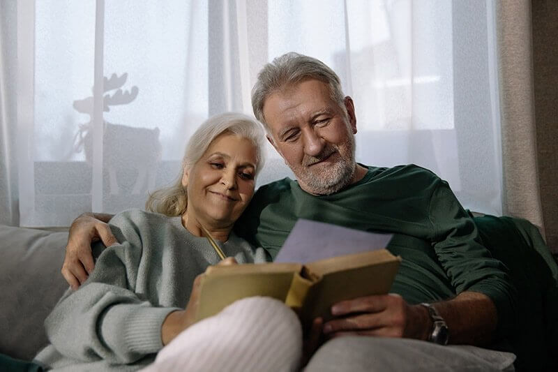 elderly couple reading together