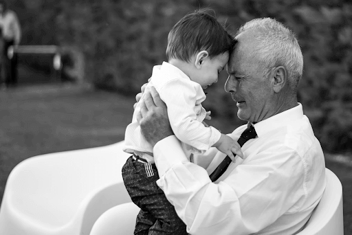 grandfather holding grandson